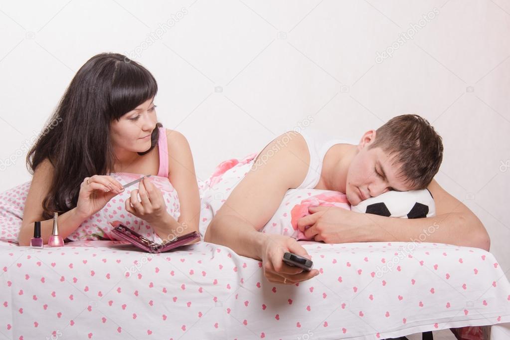 wife looks at her husband sleeping football fan