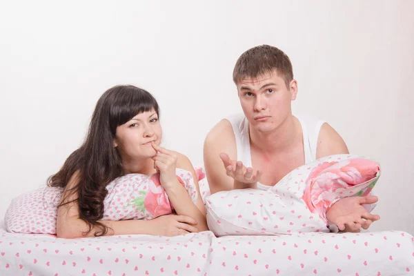 Young couple thought, lying in bed — Stock Photo, Image