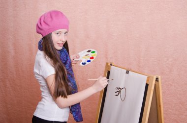 The girl begins to draw picture on the easel clipart