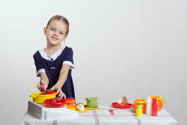 Girl hostess prevents spoon in the pan — Stock Photo, Image