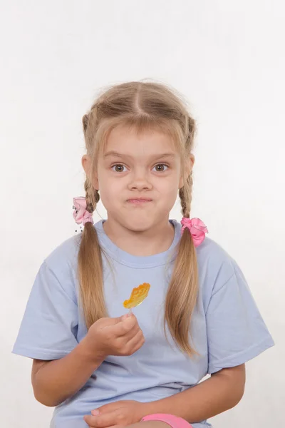 Cheerful five year girl with sweet candy in hands of — Stock Photo, Image