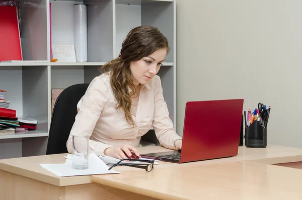 Flicka som arbetar i en laptop fokuserade — Stockfoto