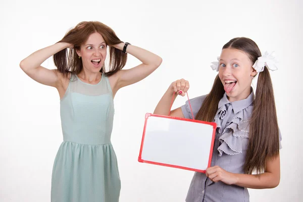 Teacher in horror looking at the student with a sign — Stock Photo, Image