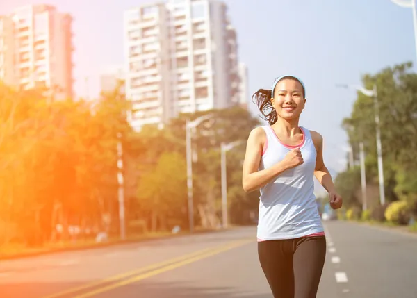 Woman running at city asphalt street — Stock Photo, Image