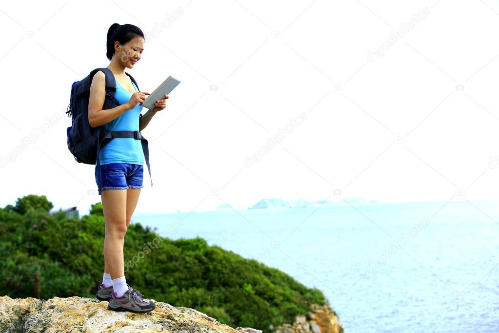 Woman hiker use tablet pc