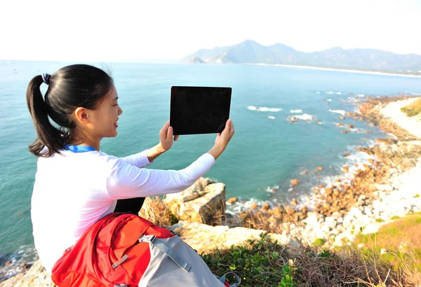 Woman on rock with digital tablet — Stock Photo, Image