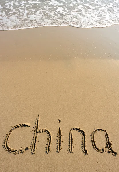 Palabra de China dibujada sobre arena — Foto de Stock