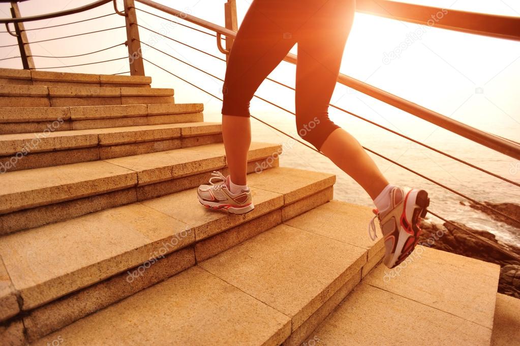 Female legs running at sunrise