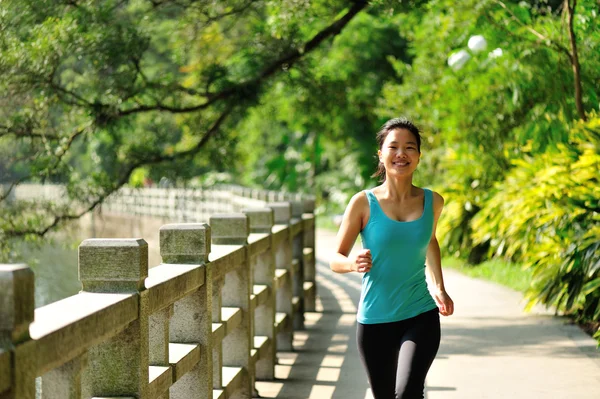 Runner athlete running at tropical park road — Stock Photo, Image