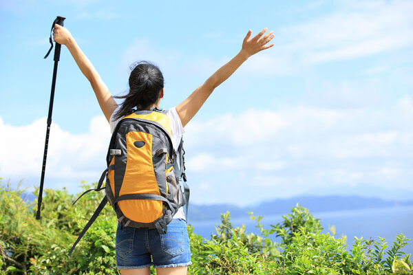 Hiking woman stand seaside