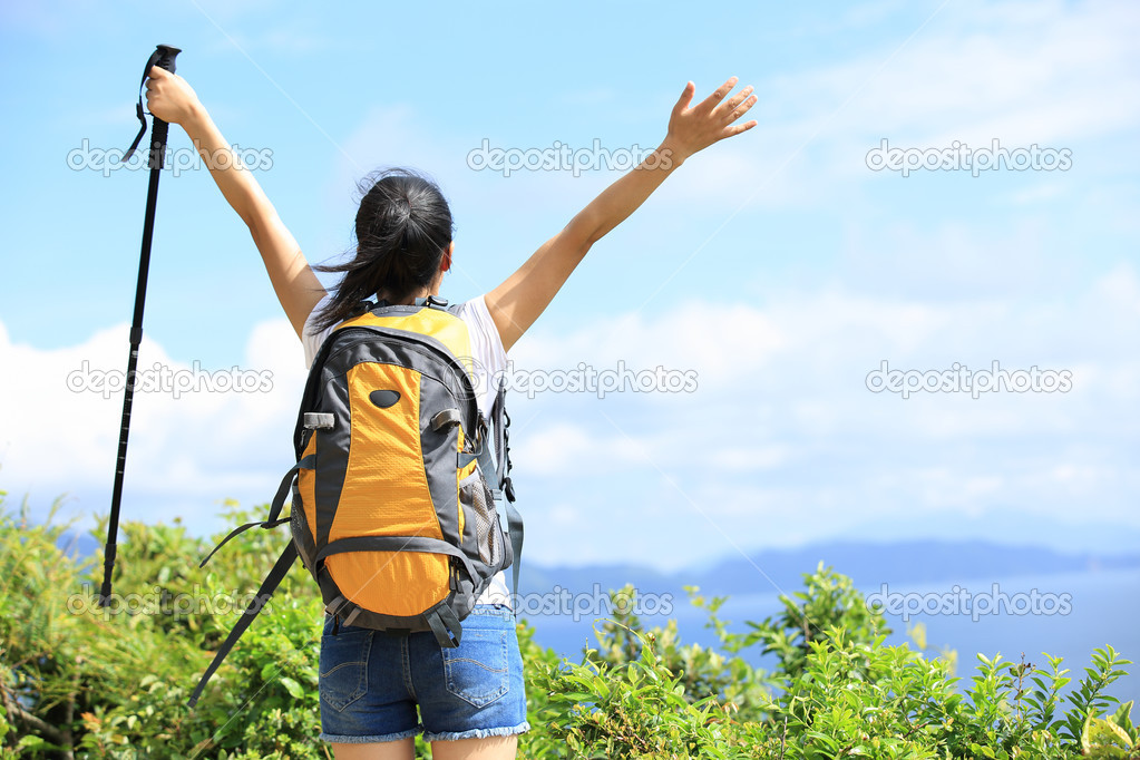 Hiking woman stand seaside