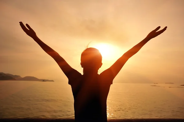 Open arms at sunset seaside beach — Stock Photo, Image