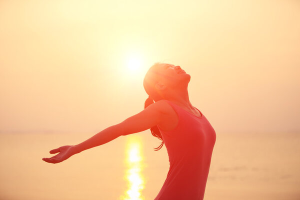 Open arms at sunset seaside beach