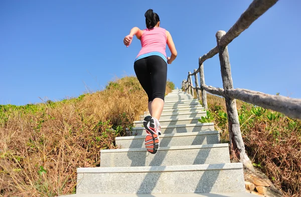 Woman running up on the  stairs — Stock Photo, Image
