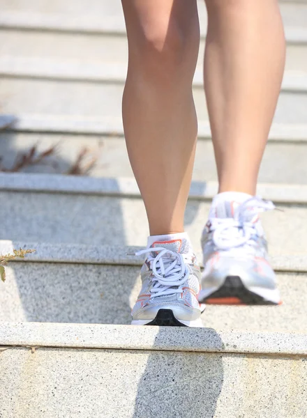 Woman running on mountain stairs — Stock Photo, Image