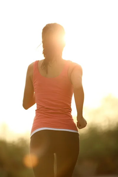 Woman running at seaside under sunrise — Stock Photo, Image