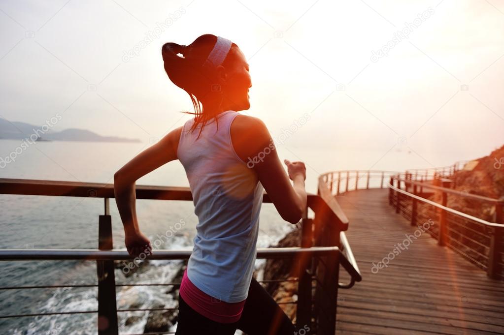 woman running on wooden pier