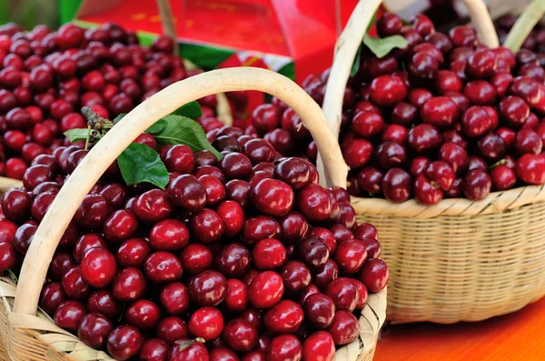 Red cherry fruits in bamboo basket — Stock Photo, Image