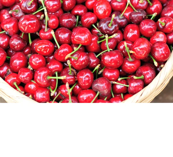 Red cherry fruits in bamboo basket — Stock Photo, Image