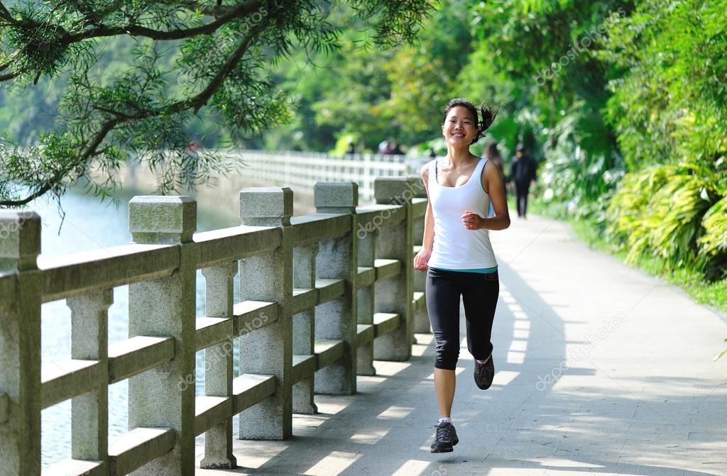 Asian woman jogging at park