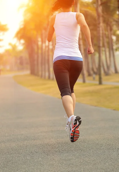 Asian woman running at tropical park — Stock Photo, Image