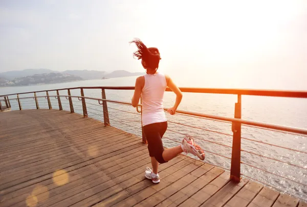 Running woman on bridge — Stock Photo, Image