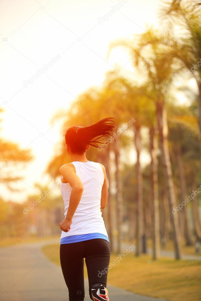 Woman running in tropical park