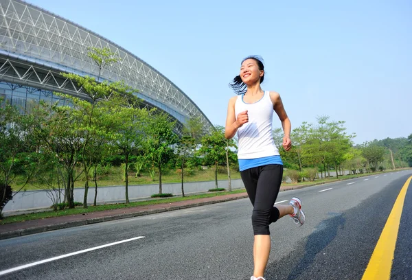 Woman running at city street — Stock Photo, Image