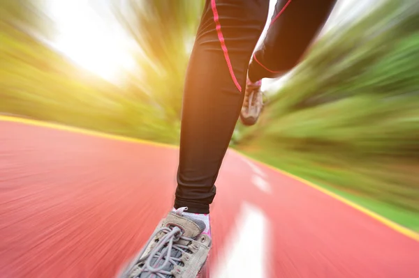 Woman runner athlete legs running on road — Stock Photo, Image