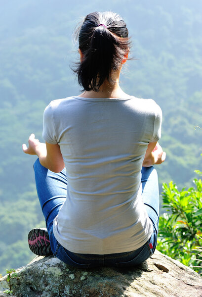 Yoga woman sit on rock