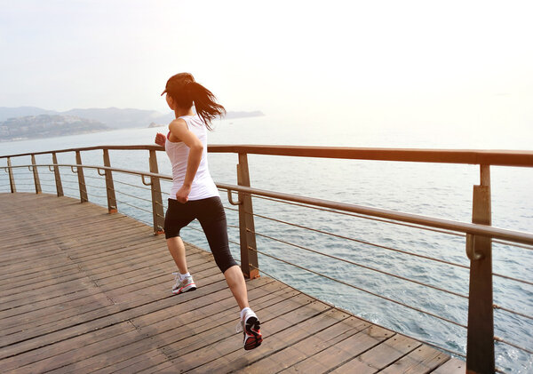 Runner athlete running on seaside