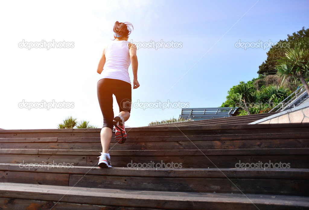 Runner athlete running on seaside stone stairs