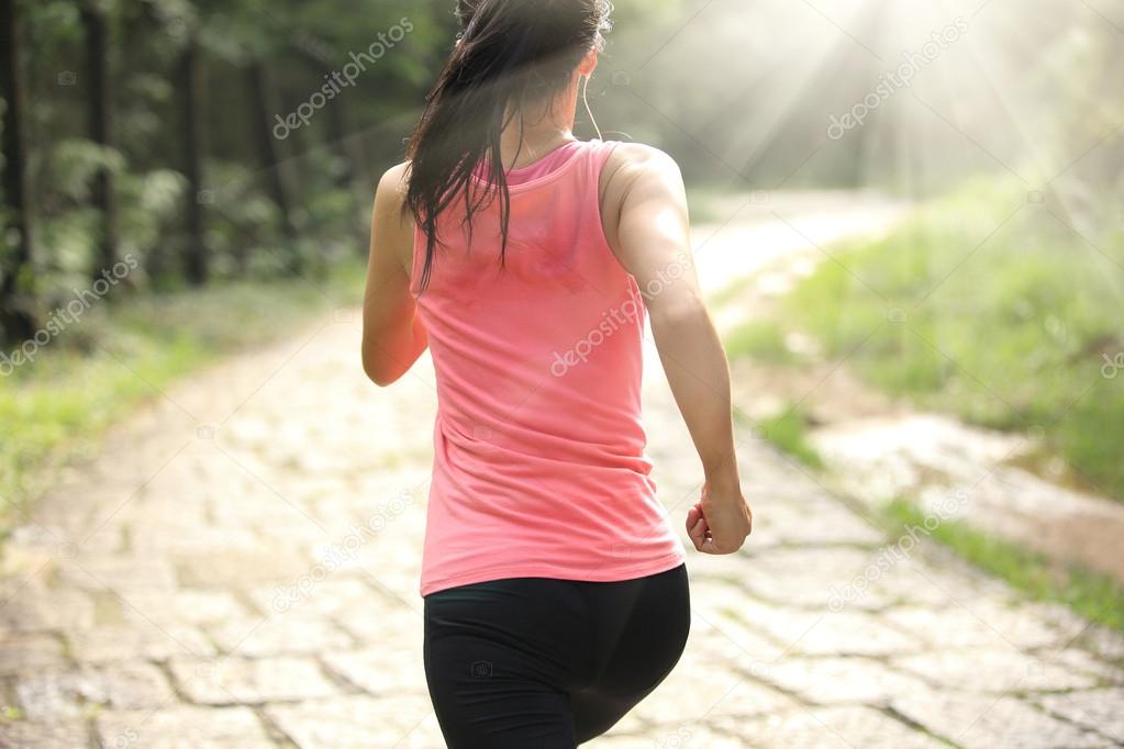 Runner athlete running on forest trail