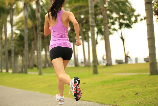 Runner athlete running at tropical park — Stock Photo, Image