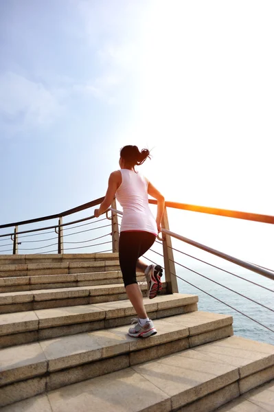 Woman athlete running at stairs — Stock Photo, Image