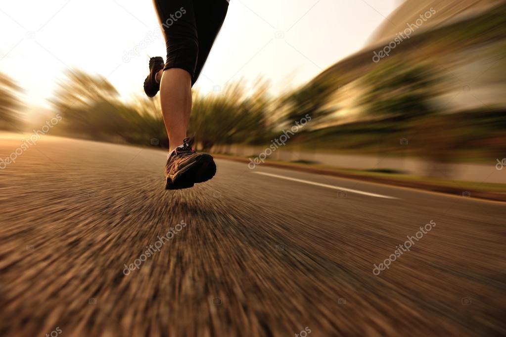 Runner athlete running on tropical park trail