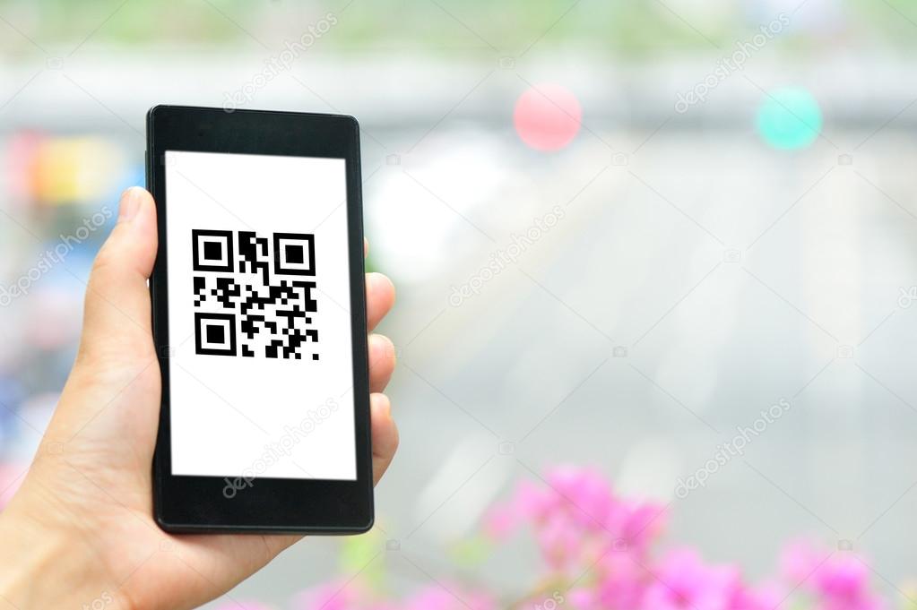 Woman hand hold smart phone with coupon QR code