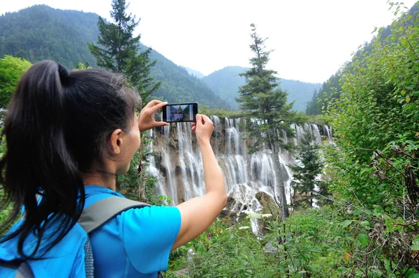 随着智能手机的女人旅游拍照 — Stockfoto