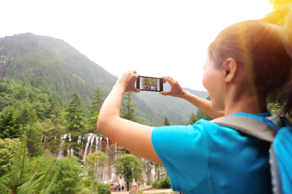 随着智能手机的女人旅游拍照 — Stockfoto