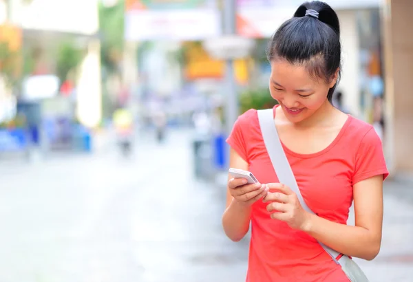 若いアジアの女性の彼女のスマート フォンを使用して — ストック写真