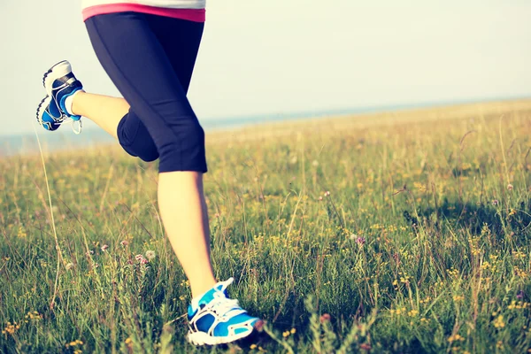 Runner athlete running on grass seaside. — Stock Photo, Image