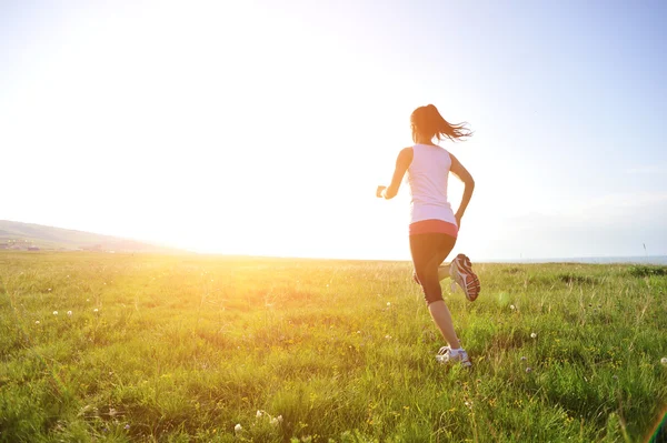 Çim sahil üzerinde çalışan runner atlet. — Stok fotoğraf