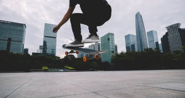 Kaykaycı şehir dışında kaykay yapıyor.