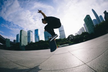 Kaykaycı şehir dışında kaykay yapıyor.