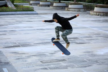 Kaykaycı şehir dışında kaykay yapıyor.