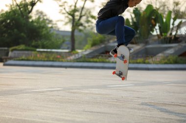 Kaykaycı şehir dışında kaykay yapıyor.