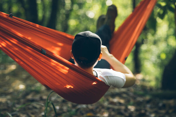 Relaxing in hammock in tropical forest