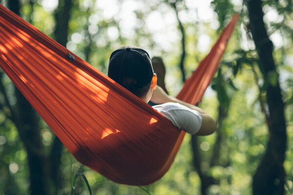 Relaxing in hammock in tropical forest