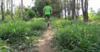 woman running through green forest