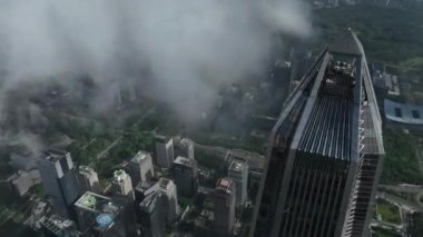 view of the city with green gardens and buildings